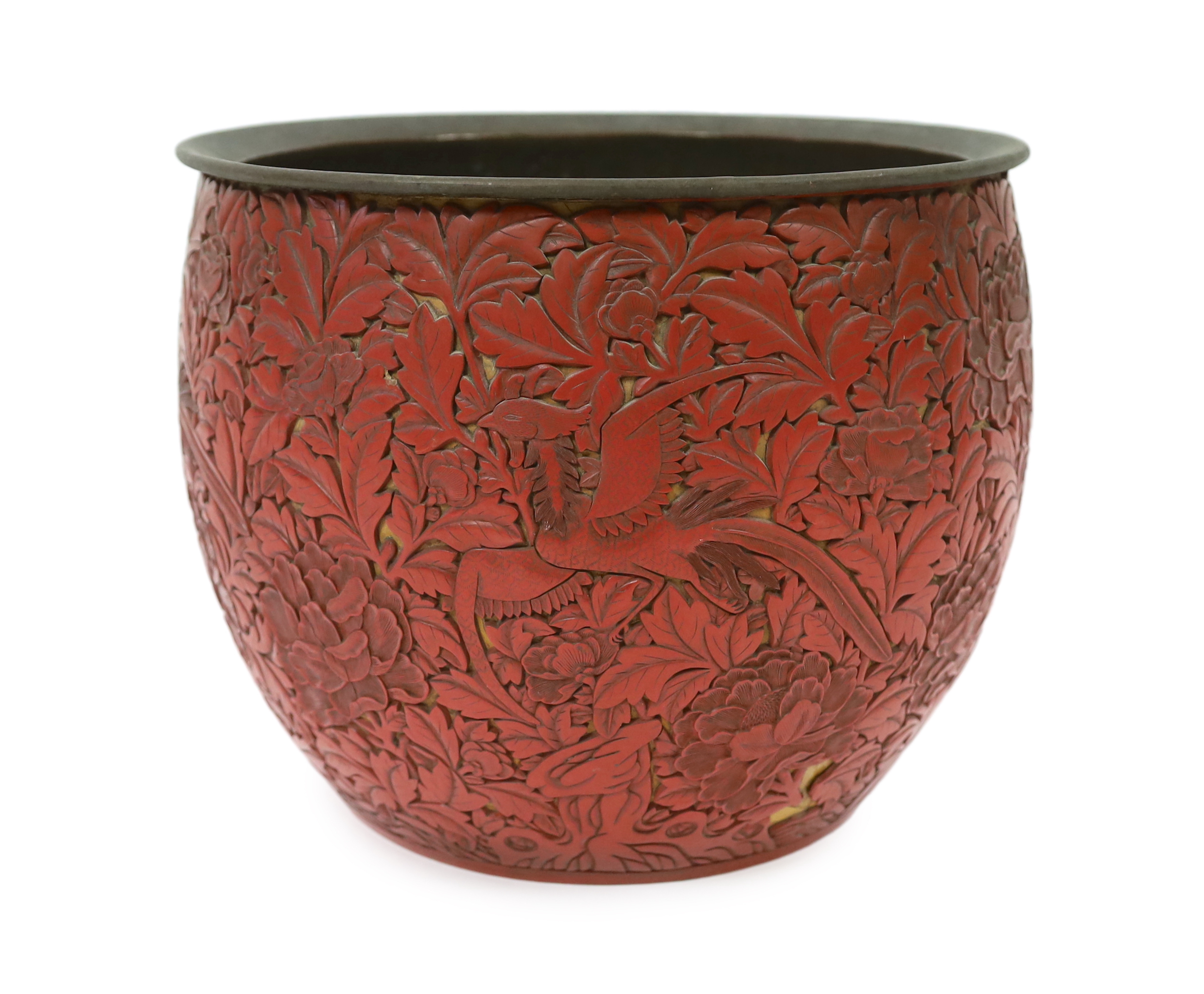 A large Chinese cinnabar lacquer ‘pheasant and peony’ jardiniere, 19th century, losses and numerous loose sections